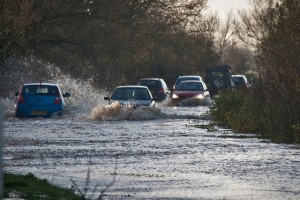 Flooding on the A361, the main road from Taunton to Glastonbury, England. Scientists warn that climate change is well underway, producing costly and tragic extreme weather events. Credit: Mark Robinson/cc by 2.0