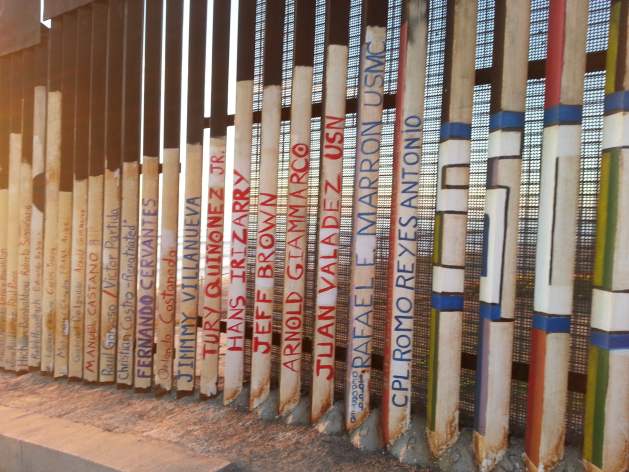 Names of migrants who died crossing, on U.S.-Mexico border fence, Tijuana. Credit: Peter Costantini