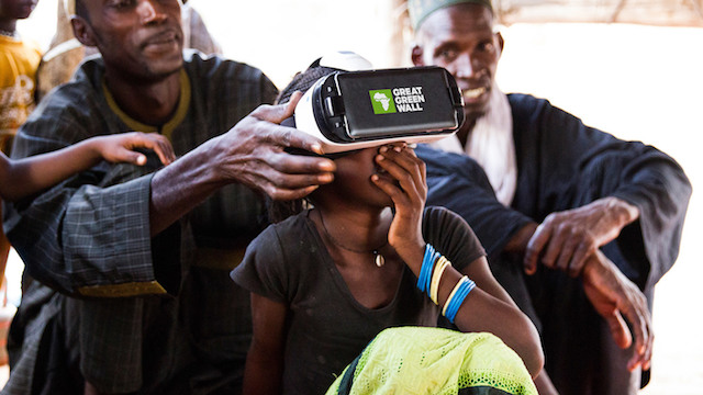 A girl learns about the project through a virtual reality headset. Credit: Greatgreenwall.org
