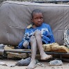An AIDS orphan sits on an old bus seat. Zimbabwe has over one million AIDS orphans. Credit: IRIN