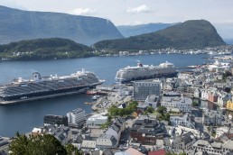 Cruise ships at the port of Aalesund, Norway dwarf many of the city’s older buildings. Credit: Trevor Page