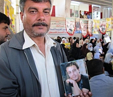 Samir Asfour with a picture of his son, Ahmed, at a weekly protest in Gaza by families of Israeli prisoners. / Credit:Pam Bailey/IPS