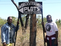 Zimbabwean war veterans hold a make-shift sign directing people to their seized farm plots. / Credit:Fidelis Zvomuya/IPS