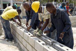 Construction workers fasten the base of the pre-fabricated Haitian Parliament facility, being built with funds from the U.N. peacekeeping mission. / Credit:UN Photo
