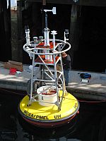 U.S. scientists make final adjustments to the first buoy measuring ocean acidification. It was deployed Jun. 7 in the Gulf of Alaska. / Credit:NOAA