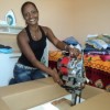 An excited Rosemere Souto unpacks her brand-new industrial sewing machine.  Credit: Fabiana Frayssinet /IPS