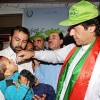 Cricket icon and politician Imran Khan lends a hand with oral polio vaccination. Credit: Ashfaq Yusufzai/IPS