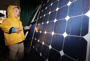 Three-year-old Henry Shales, visiting from New York, takes a close look at a solar panel on display at the DOE Solar Decathlon 2011. Credit: Stefano Paltera/U.S. Department of Energy Solar Decathlon