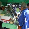 Adelaida Avelino (in the baseball cap) with customers at her market stall.  Credit: Emilio Godoy/IPS 