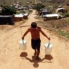 Hauling water at the Chico Mendes camp for landless peasants in Pernambuco, Brazil.  Credit: Alejandro Arigón/IPS