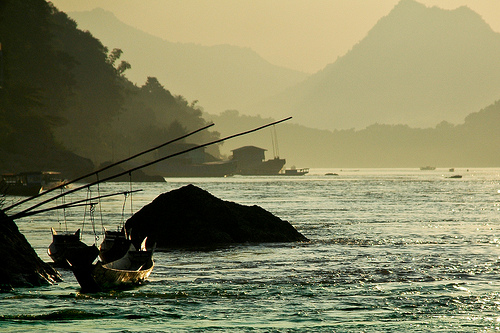 Fishermen's boats on the warlord-infested Mekong River in northern Laos.  Credit:  Irwin Loy/IPS