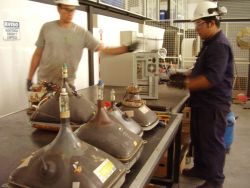 Workers at Gestión Ambiental, a company devoted to the collection, treatment and final disposal of electric and electronic waste in Buenos Aires.  Credit: Juan Moseinco/IPS