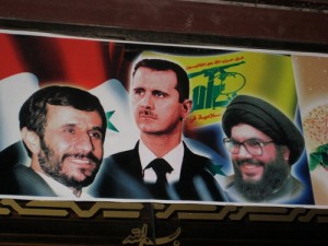 A poster in Damascus, Syria, features Iranian President Mahmoud Ahmedinejad, Syrian President Bashar al-Assad and Hezbollah leader Hassan Nasrallah. Credit: Elizabeth Whitman/IPS