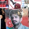 Zarmine Baloch holding the photo of her slain brother Sangat Sana outside the Karachi Press Club.  Credit:  Fahim Siddiqi/IPS