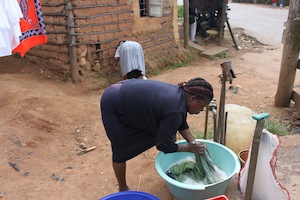 Margaret Gamedze earns a living doing laundry for people in her community in Msunduza, Swaziland.  Credit: Mantoe Phakathi/IPS