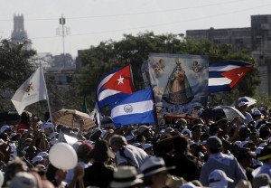 An image of the Virgin Mary next to Cuban flags in the Plaza de la Revolución.  Credit: Jorge Luis Baños/IPS