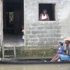 Family in a flooded village on the banks of the Atrato River in Chocó, Colombia.  Credit: Jesús Abad Colorado/IPS