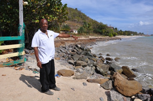 In Antigua, Evi Johnson points to where his favourite beach, now eroded, used to be.  Credit: Credit: Desmond Brown/IPS