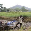Emmanuel Kargbo, a 26-year-old farmer, pushes a motorised soil tiller recently given to his farming cooperative. Credit: Damon Van der Linde/IPS 