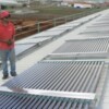 A technician inspecting the solar panels at RT Knits Ltd. Credit:  Nasseem Ackbarally/IPS