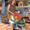 An American researcher poses with fair trade baskets in Kampala, Uganda. Credit:  Wambi Michael/IPS