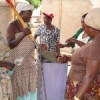 Members of the Katosi Women Development Trust building a cistern to store rainwater. Credit:  Joshua Kyalimpa/IPS