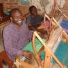 Wheelchair-bound weavers at Neema Crafts in Iringa. Credit:  Sarah McGregor/IPS