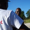 A Namibian Red Cross volunteers talks to flood-displaced people. Credit:  IFRC/IPS