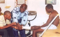 Olukoye (centre) at work in his Oshodi clinic. Credit:  Toye Olori/IPS