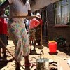 Drawing water from a well in Zengeza, a densely-populated neighbourhood of the satellite town of Chitungwiza. Credit:  Ncube Ntando/IPS