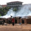 Smoking fish at Ggaba: these kilns, and the houses behind them, are too close to the shoreline, polluting the water - contributing to driving fish stocks down. Credit:  Pius Sawa/IPS/IFEJ
