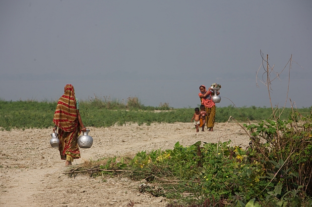 In parts of Bangladesh that have turned arid women may trudge several km to fetch drinking water for their families. Credit: Sujan Map/IPS