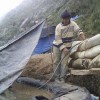 Small-scale miner next to cyanide leaching pit in Peru.  Credit:Milagros Salazar/IPS