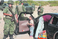 Mexican soldiers at the scene of a crime near the U.S. border. Credit: Courtesy of El Diario de Ciudad Juárez