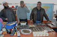 Abdulhakim Belhasi (r), the spokesperson for the Libyan special police unit set up in 2012 under the crime squad to fight drug and alcohol trafficking, with two men from the sqaud. Credit: Maryline Dumas/IPS