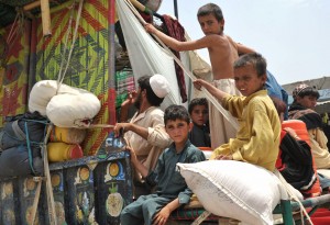 Displaced children on their way to Bannu, one of the largest cities in Pakistan’s Khyber Pakhtunkhwa (KP) province, after they were directed to leave their home in North Waziristan Agency due to a military operation against the Taliban, launched on Jun. 15, 2014. Credit: Ashfaq Yusufzai/IPS