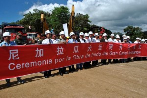 Executives of the Chinese company HKDN and members of the Nicaraguan Grand Interoceanic Canal Commission, behind a large banner on Dec. 22, 2014, in the Pacific coastal town of Brito Rivas, during the ceremony marking the formal start of the gigantic project that will cut clean across the country. Credit: Mario Moncada/IPS