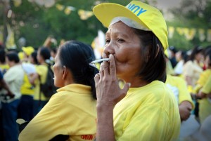 A woman smokes a cigarette branded ‘Fortune’ at a campaign rally for Philippine President Benigno Aquino III, a smoker who has said he has no intention of quitting the habit. The Philippines has the second highest number of smokers in South-east Asia. Credit: Kara Santos/IPS