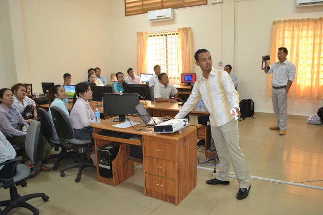 Srun Srorn, a trainer for the E-learning project, walks teachers at Koh Kong High School in Cambodia through a new online sexual education curriculum. Credit: Michelle Tolson/IPS