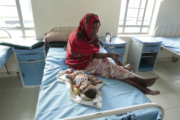 A new mother watches over her child at the Ifo 2 Refugee Camp Hospital in Dadaab, Kenya, which is supported by the United Nations High Commissioner for Refugees (UNHCR). Credit: UN Photo/Evan Schneider