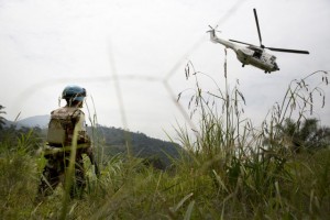 A Uruguayan peacekeeper with UN Organization Stabilization Mission in the Democratic Republic of the Congo (MONUSCO) watches as the helicopter carrying Under-Secretary-General for Peacekeeping Operations, Hervé Ladsous, makes its way back toward Goma after Mrs. Ladsous’ visit in Pinga, North Kivu Province. Credit: UN Photo/Sylvain Liechti