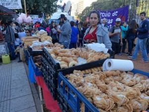A young street vendor sells typical Argentine baked goods in a market near the Plaza de los dos Congresos, in Buenos Aires. Credit: Fabiana Frayssinet/IPS