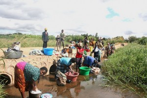Washing clothes in a stream, Mchinji District, Malawi. Goal-setting can lift millions of people out of poverty, empower women and girls, improve health and well-being, and provide vast new opportunities for better lives. Credit: Claire Ngozo/IPS