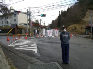 A reporter stands at a roadblock outside Fukushima's 20 kilometre exclusive zone in March 2011. Credit: Suvendrini Kakuchi/IPS