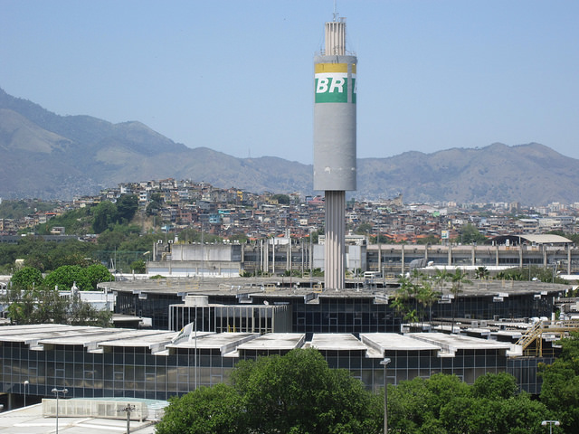 A circular laboratory and office building in CENPES, built in 1973 on University City Island in Rio de Janeiro. The Maré and Floresta de Tijuca favelas or shantytowns can be seen in the background. CENPES is the R&D arm of Brazil’s state oil company Petrobras, whose symbol is BR. Credit: Mario Osava/IPS