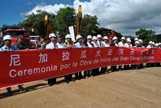 Executives of the Chinese consortium HKDN-Group behind a big sign on Dec. 22, 2014 in the town of Brito Rivas on the Pacific ocean coast, at the ceremony for the formal start of construction of the Great Canal of Nicaragua, which will cut across the country. Credit: Mario Moncada/IPS