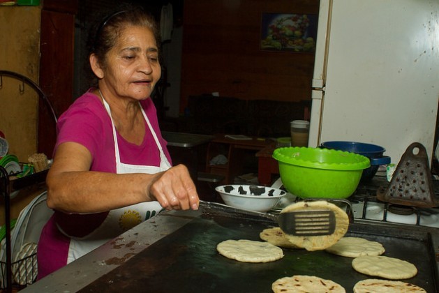Juana Morales is cooking pupusas – thick tortillas with different kinds of fillings. Hers, however, are not made with corn tortillas, but with ojushte, a highly nutritional seed whose consumption is being promoted in the small town of San Isidro in western El Salvador. Credit: Edgardo Ayala/IPS