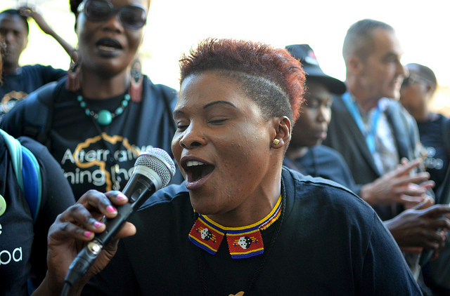 An Alternative Mining Indaba delegate from Swaziland sings protest songs. There was a feeling of triumph among the delegates after achieving even a degree of acknowledgement from industry representatives. Credit: Mark Olalde/IPS