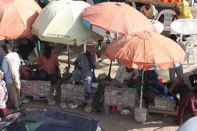 Peace and security hold in Somaliland, so effectively that moneychangers can safely stash bundles of cash on the street. Credit: James Jeffrey/IPS