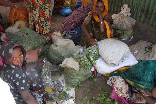 A woman and child surrounded by bags of khat they’ve brought to sell at Dire Dawa’s Chattara Market, Ethiopia. Credit: James Jeffrey/IPS